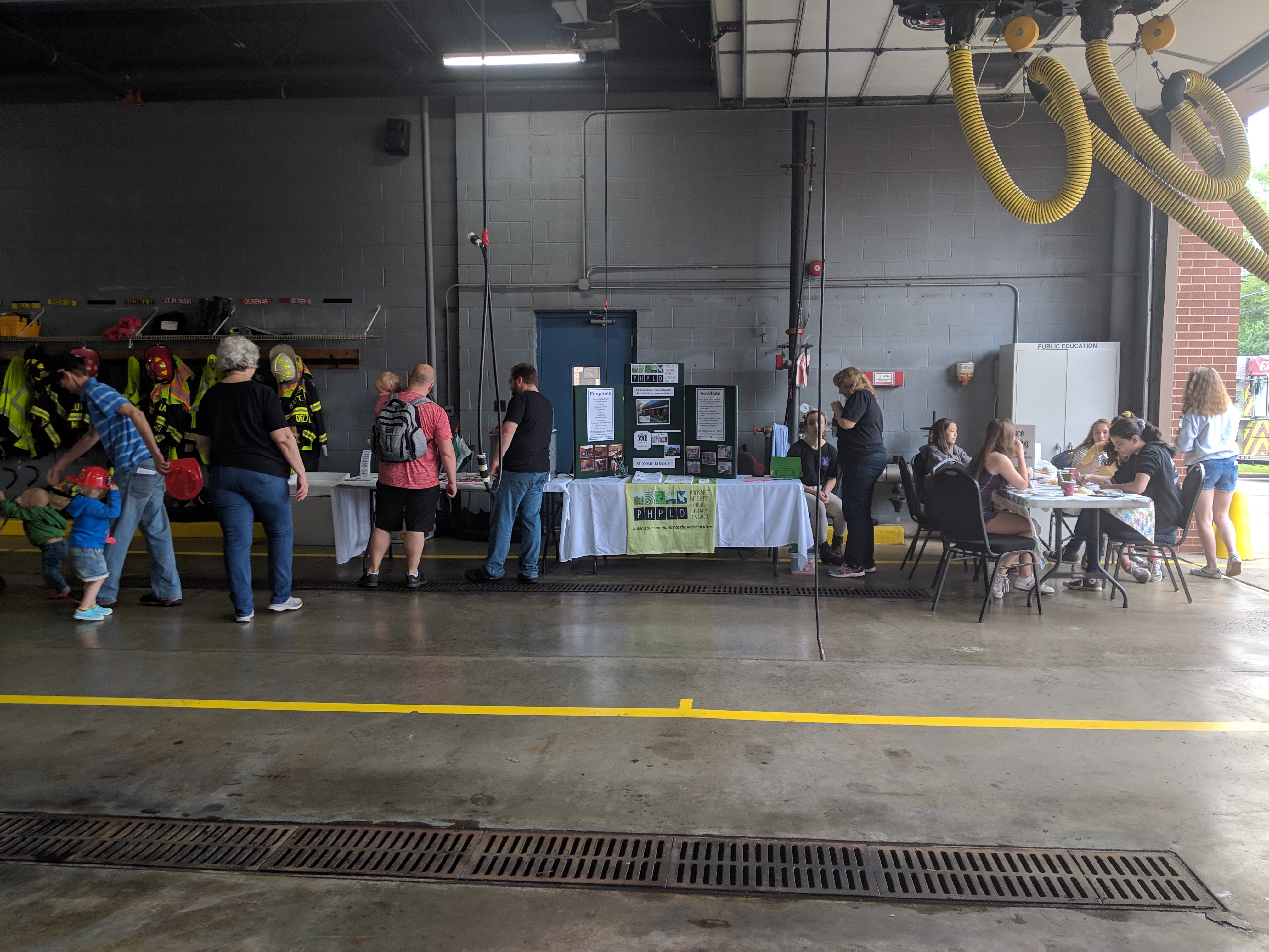 Community Day event guests at various display tables