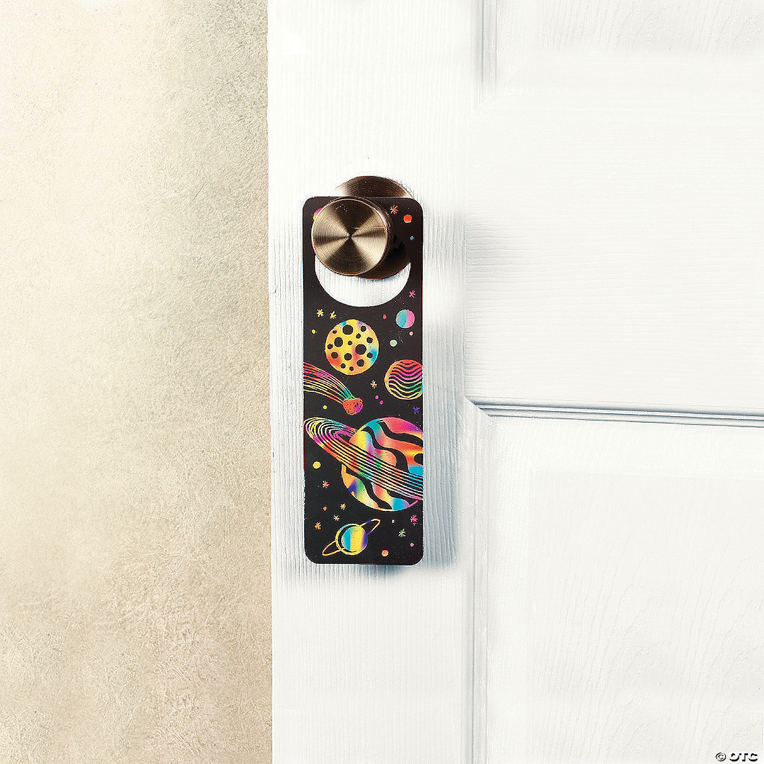 photo of a black door hanger decorated with rainbow space designs