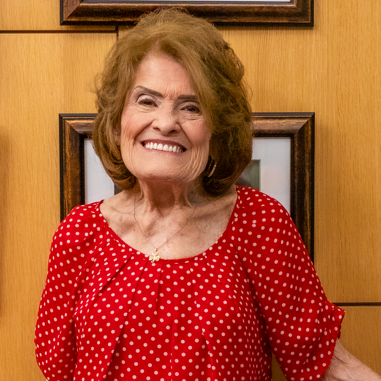 Photo of Peggy Lahey our Board Member standing in our cafe smiling at the camera.