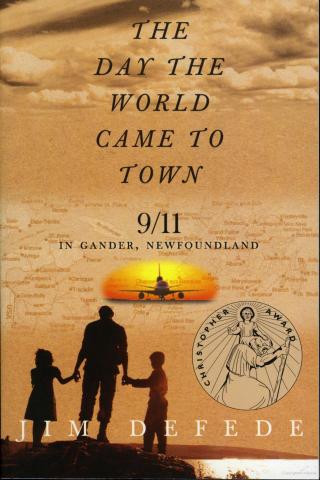 A family looks over the water at an approaching plane at sunset