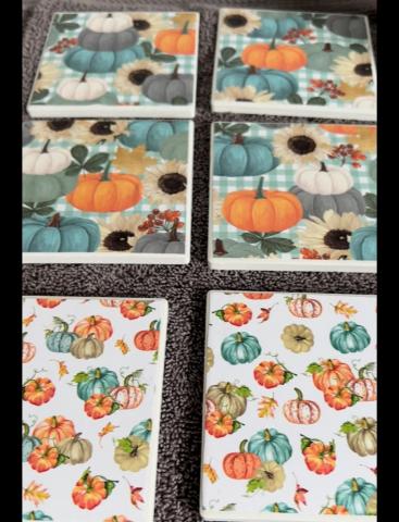 Ceramic coasters with a fall theme modge podged onto them.